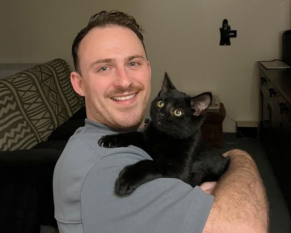 MoreFM producer Tyler holding his SPCA kitten Jim